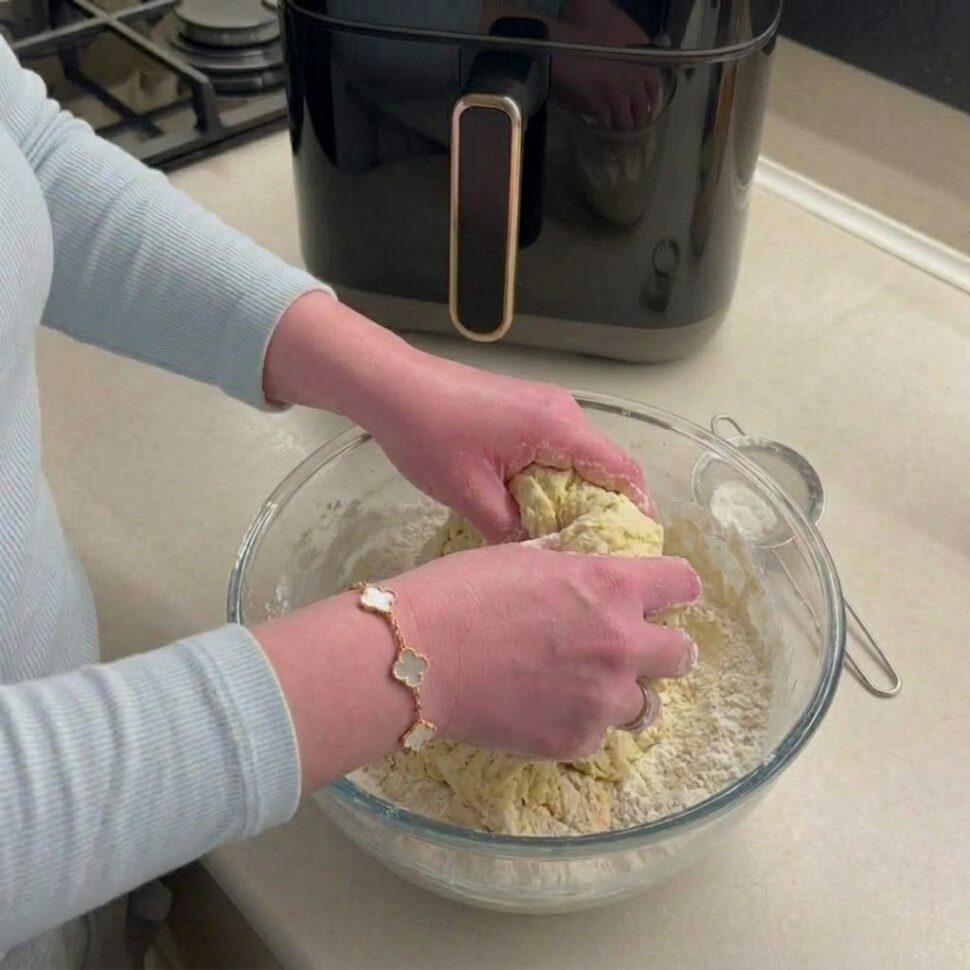 Dough being kneaded on a floured surface until smooth and elastic