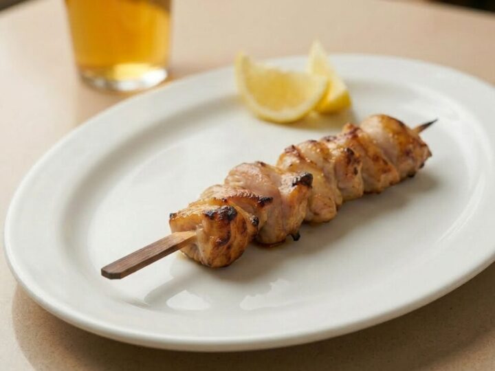 Chicken skewers cooking in an air fryer until golden brown with slightly charred edges