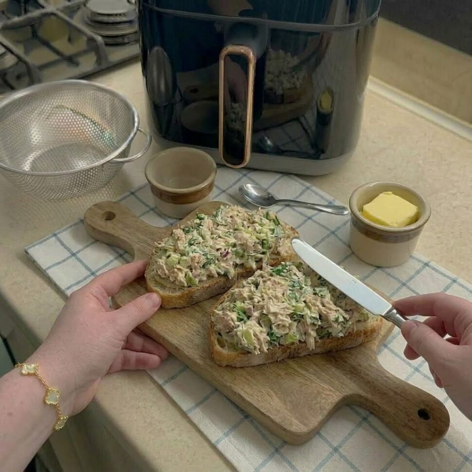 Bread slices being spread with softened butter evenly on one side