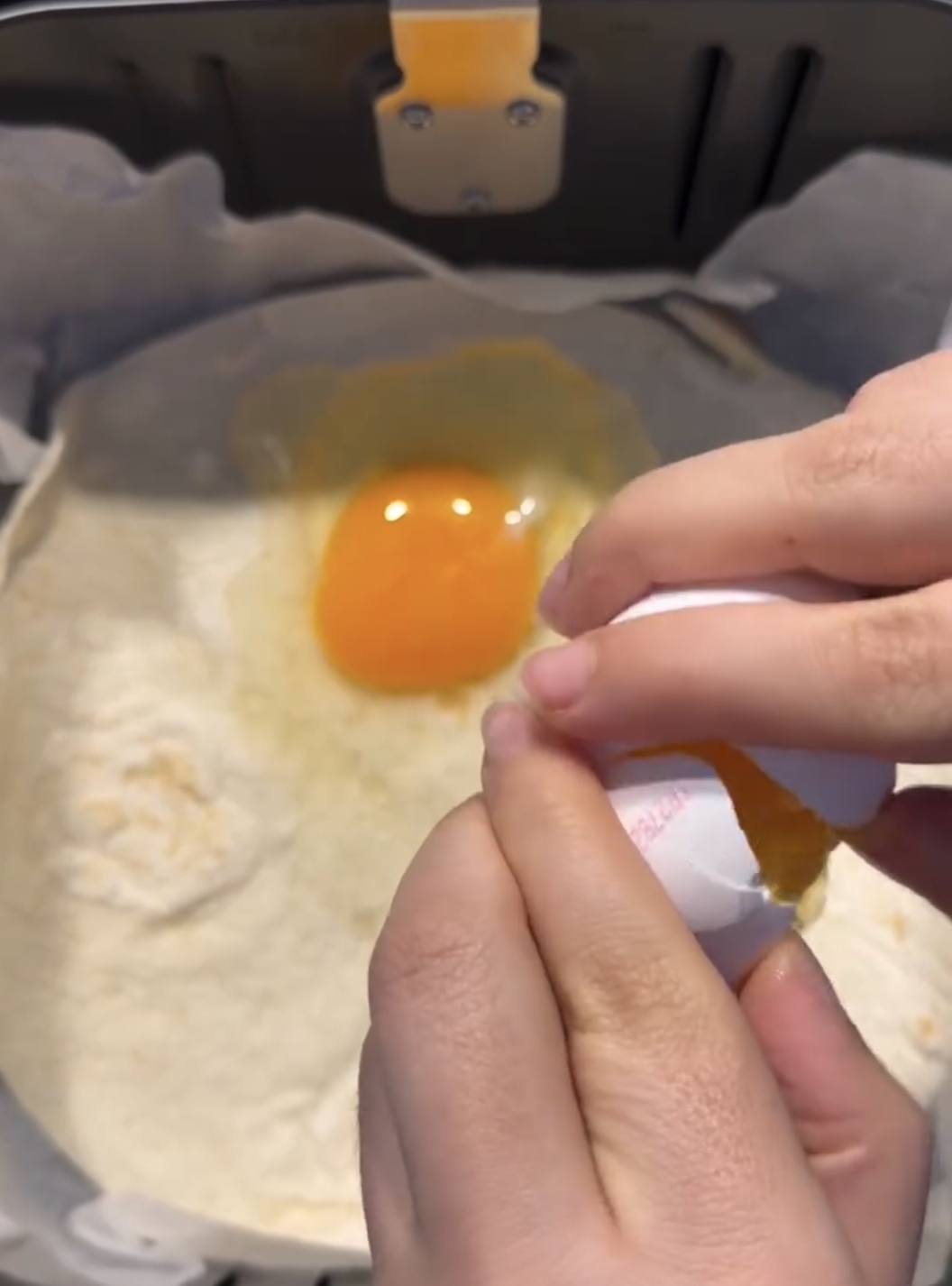 eggs poured over tortilla to start omelette in air fryer