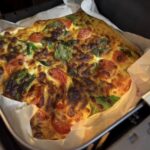 assembled tortilla omelette with tomato basil and cheese before air frying