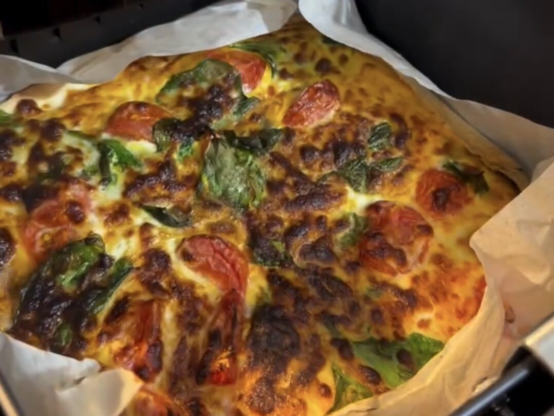 assembled tortilla omelette with tomato basil and cheese before air frying