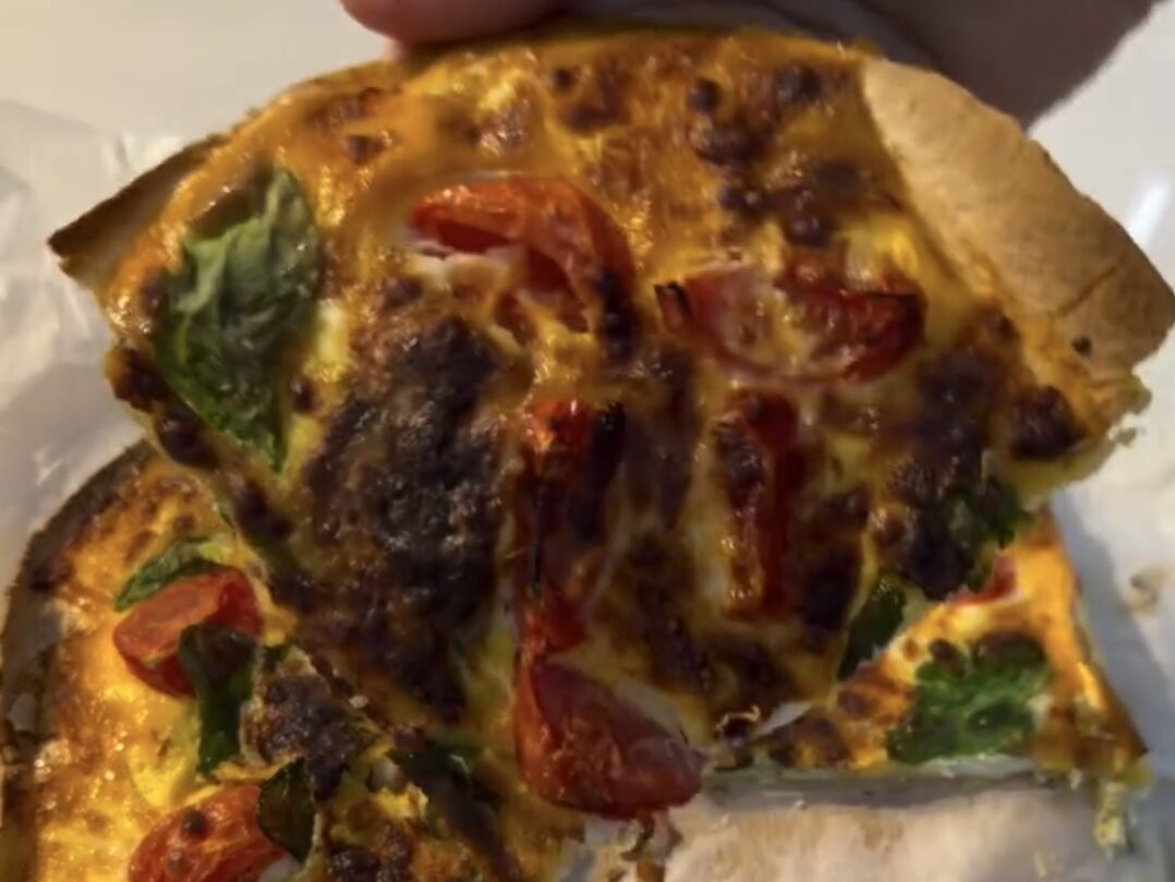 sliced tortilla omelette showing cheesy tomato basil filling