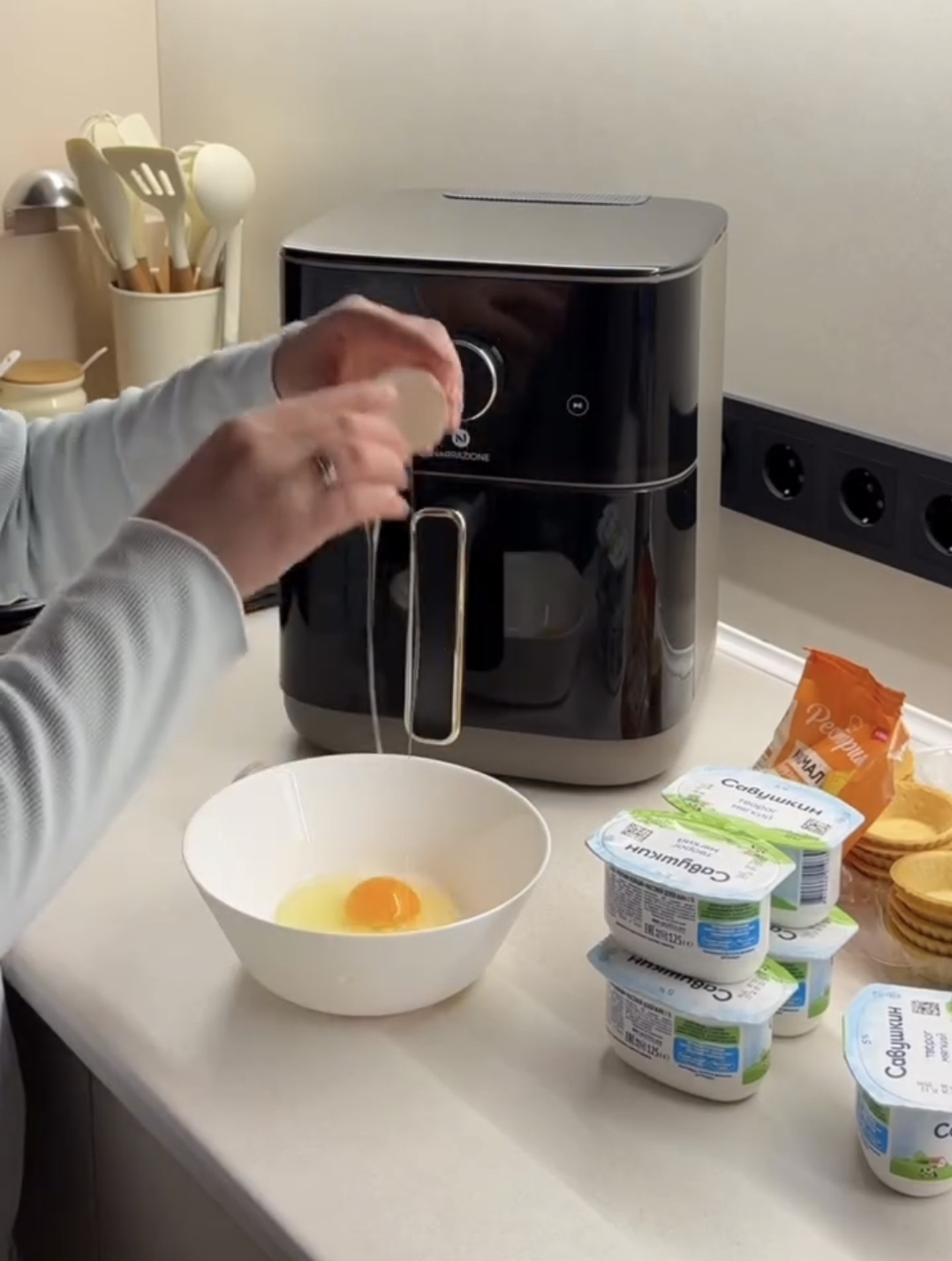 air fryer raspberry casserole eggs being added to the white mixing bowl