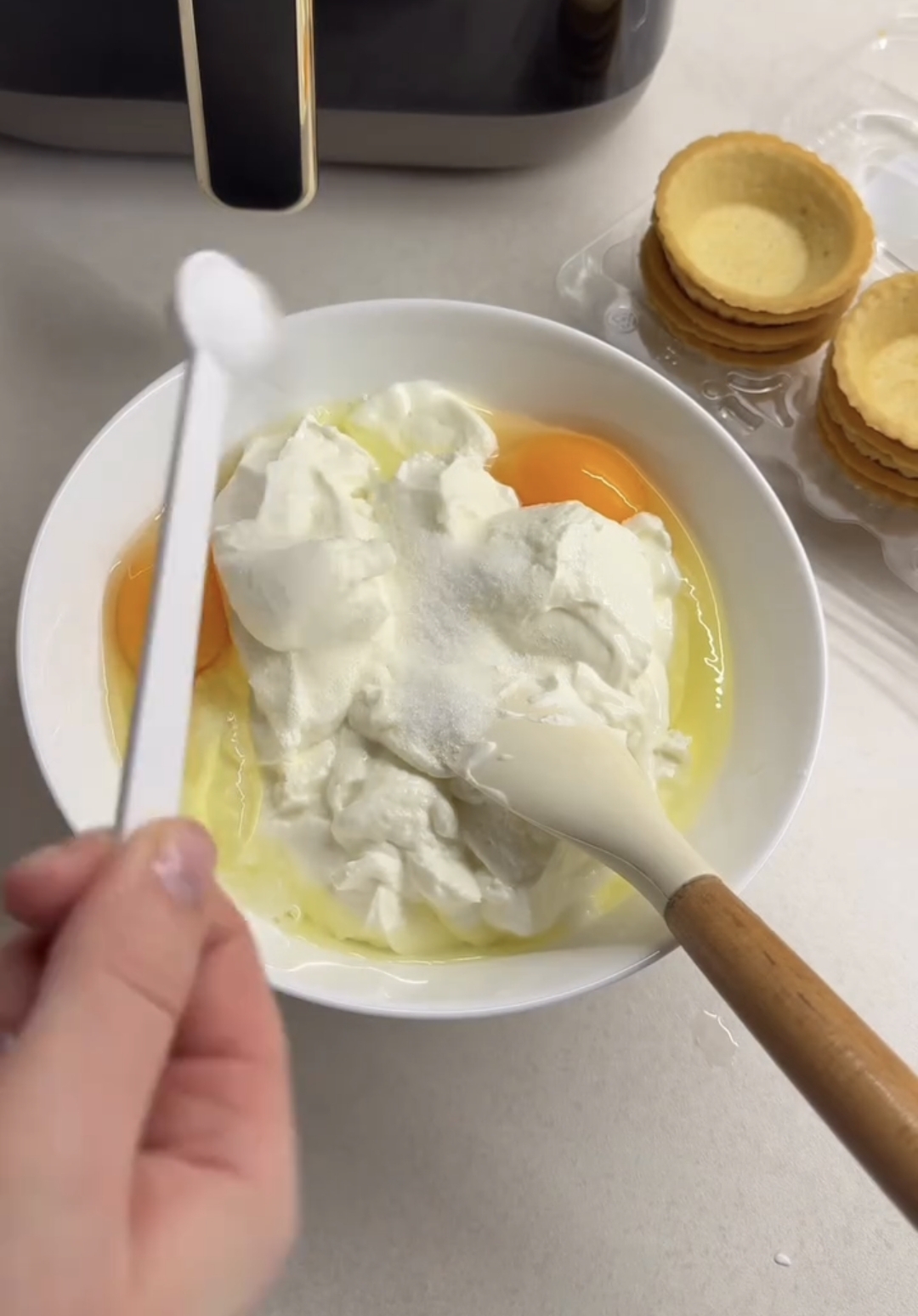 air fryer raspberry casserole sugar measured into the mixing bowl with a spoon