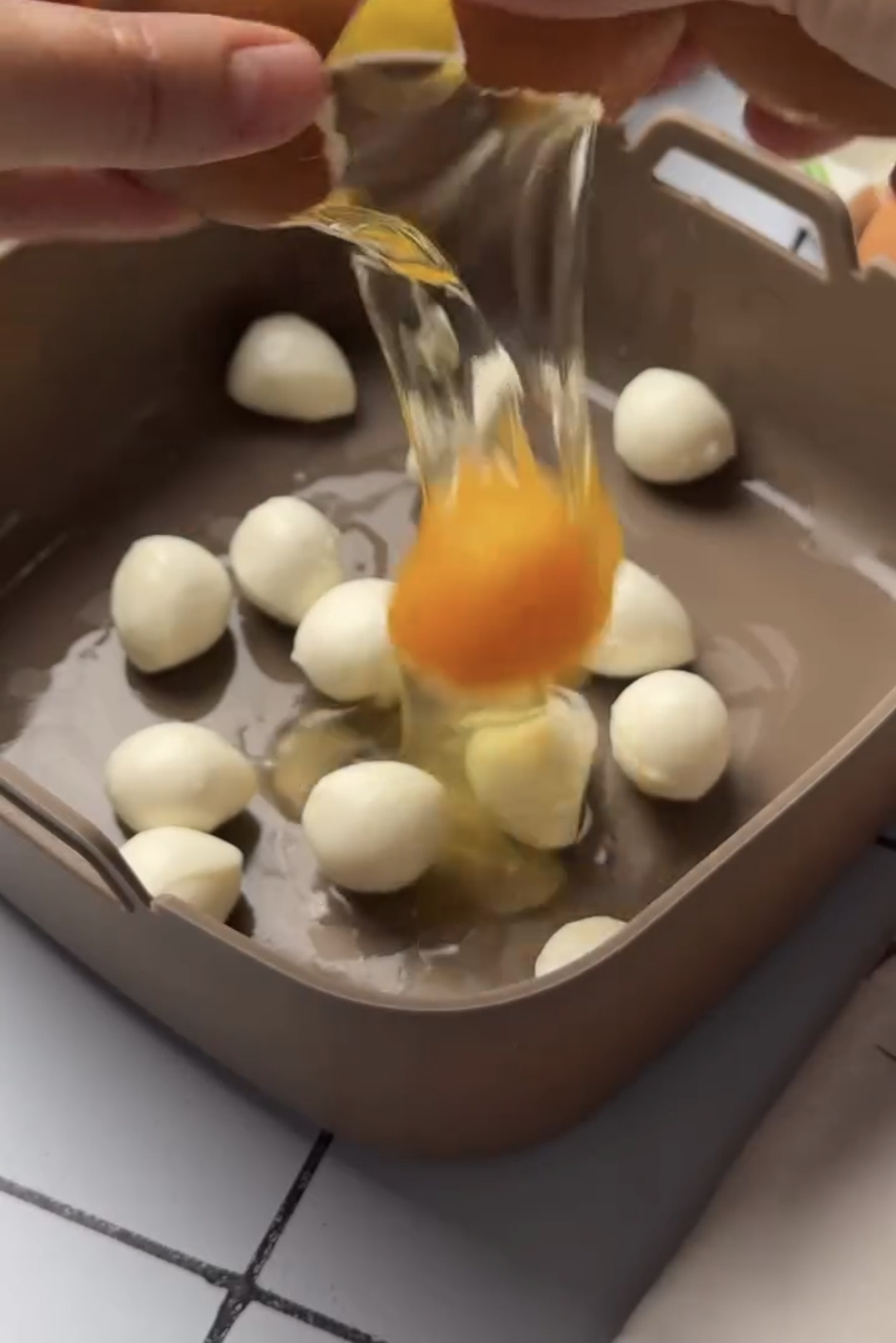 10-minute air fryer breakfast egg mixture and yellow cheese poured over the hash