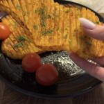 air fryer accordion potatoes stretched to show the lattice pattern after cutting