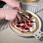 golden crispy roti tart with melted creamy cheese and juicy raspberries