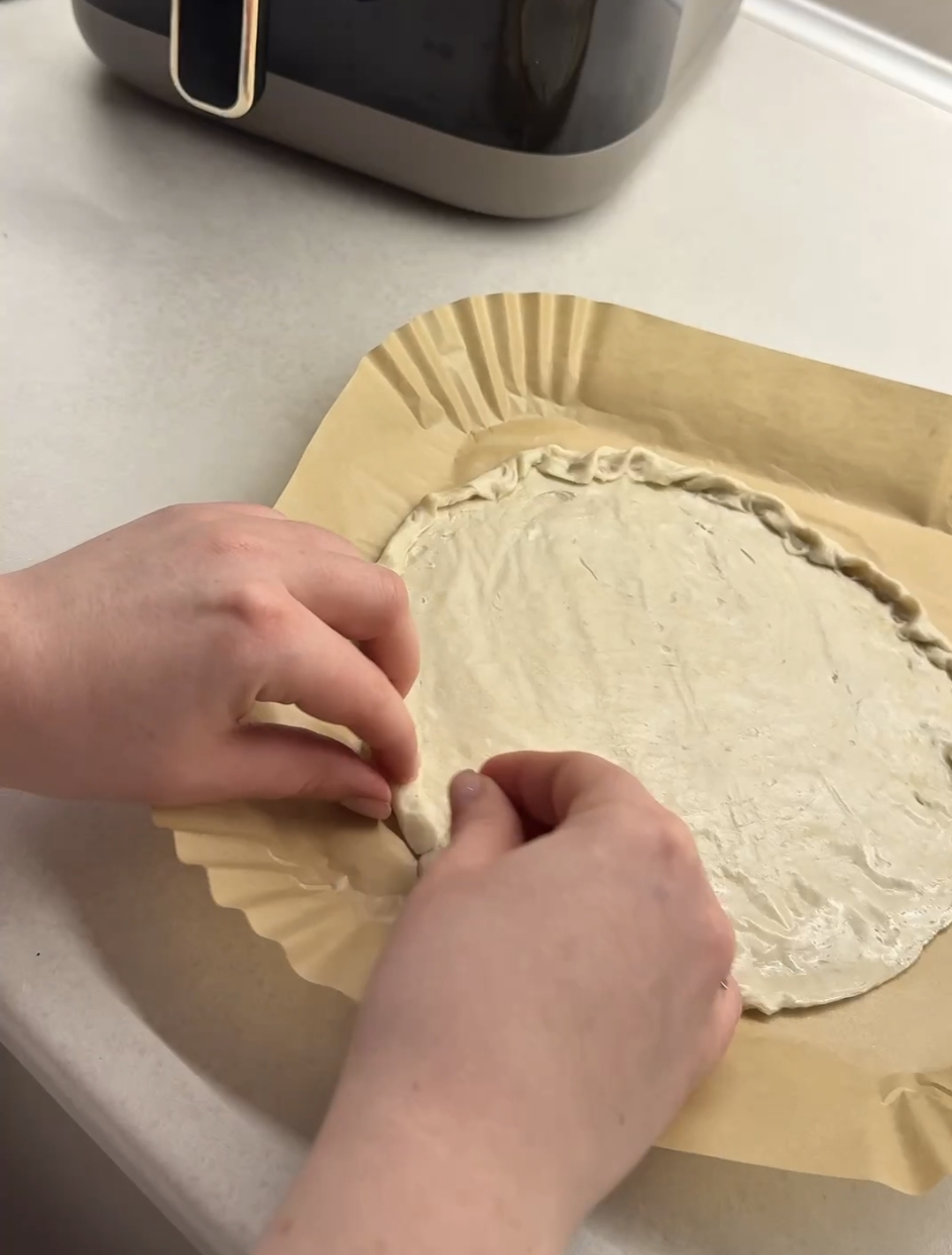 soft roti flatbread slightly thawed and shaped with raised edges on parchment paper