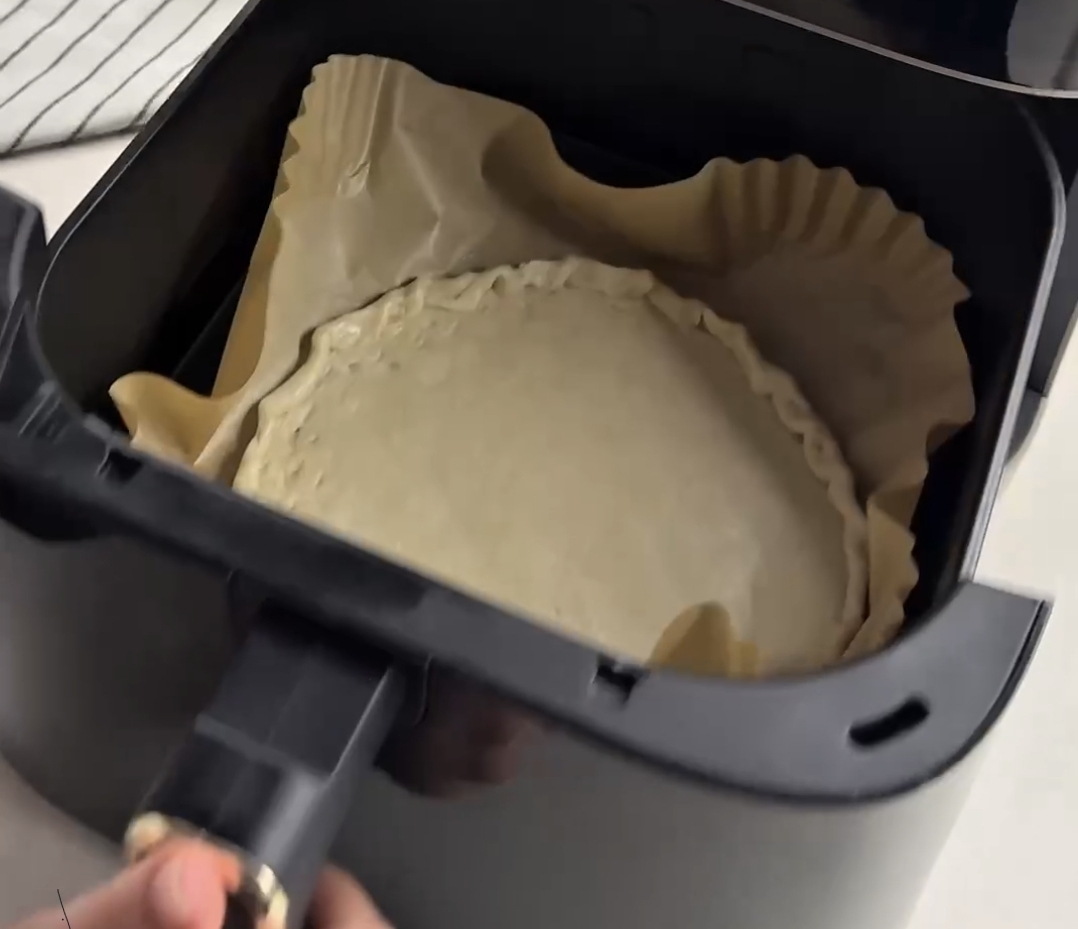 hands folding and pinching roti edges to create a tart crust shape