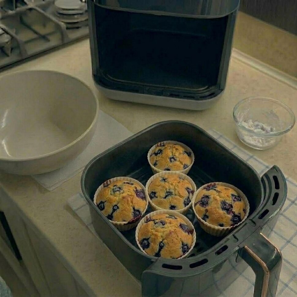 Close-up of muffin showing fluffy interior with bursting blueberries