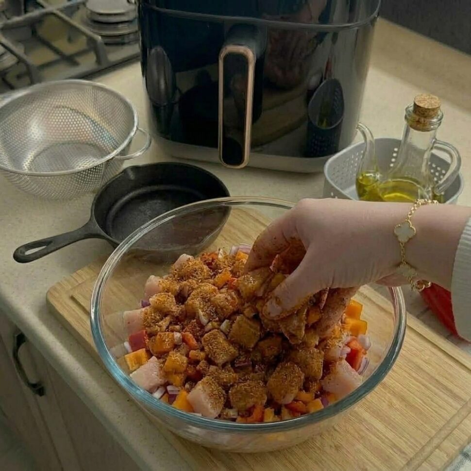 Ground turkey mixed with ricotta parmesan breadcrumbs egg herbs and spices in a bowl