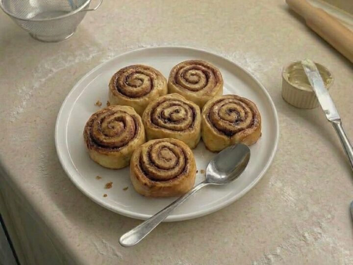 Close-up of cinnamon rolls showing soft fluffy layers with rich cinnamon sugar swirls