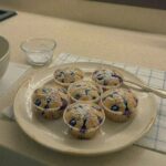 Batch of air fryer blueberry muffins with golden tops and bakery style rise