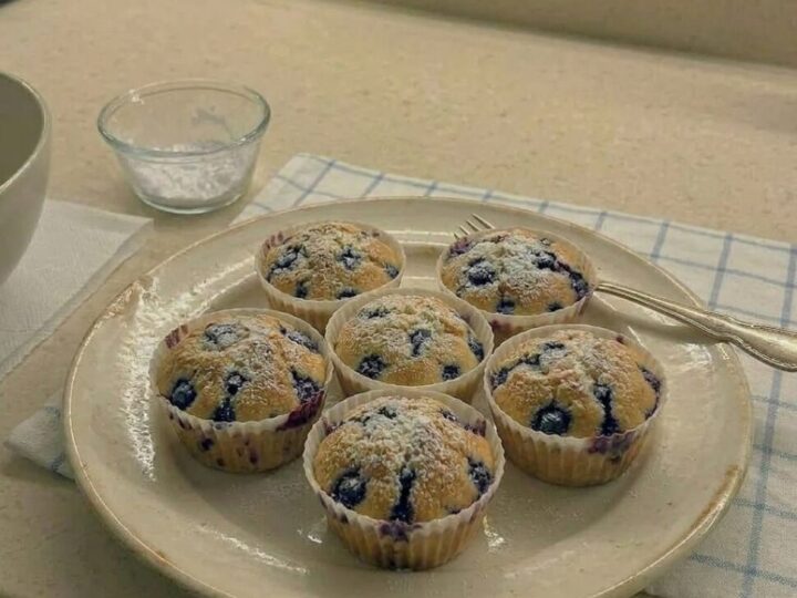 Batch of air fryer blueberry muffins with golden tops and bakery style rise