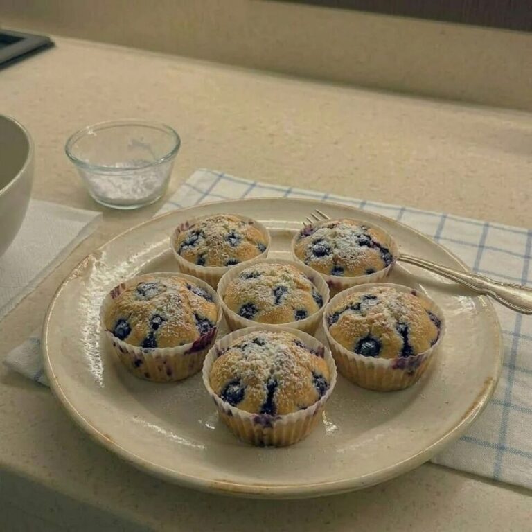 Batch of air fryer blueberry muffins with golden tops and bakery style rise