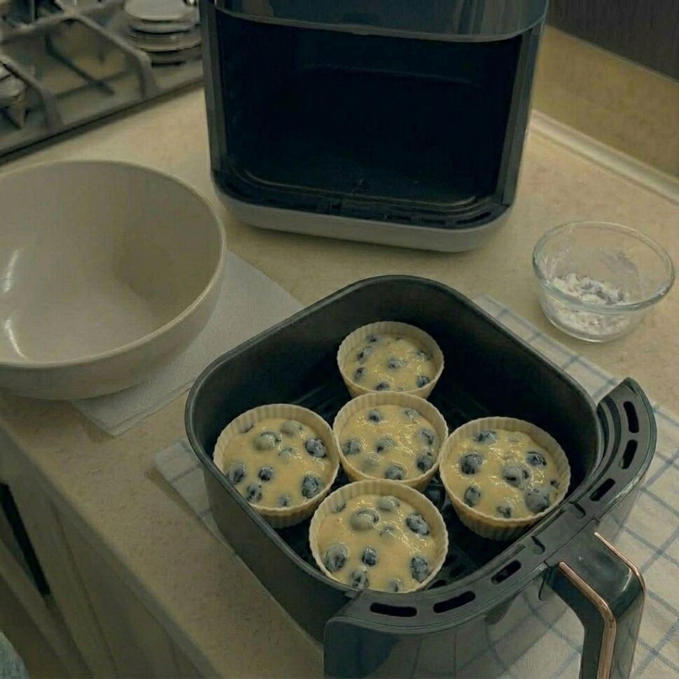 Fresh blueberry muffins served warm with soft crumb and juicy fruit inside