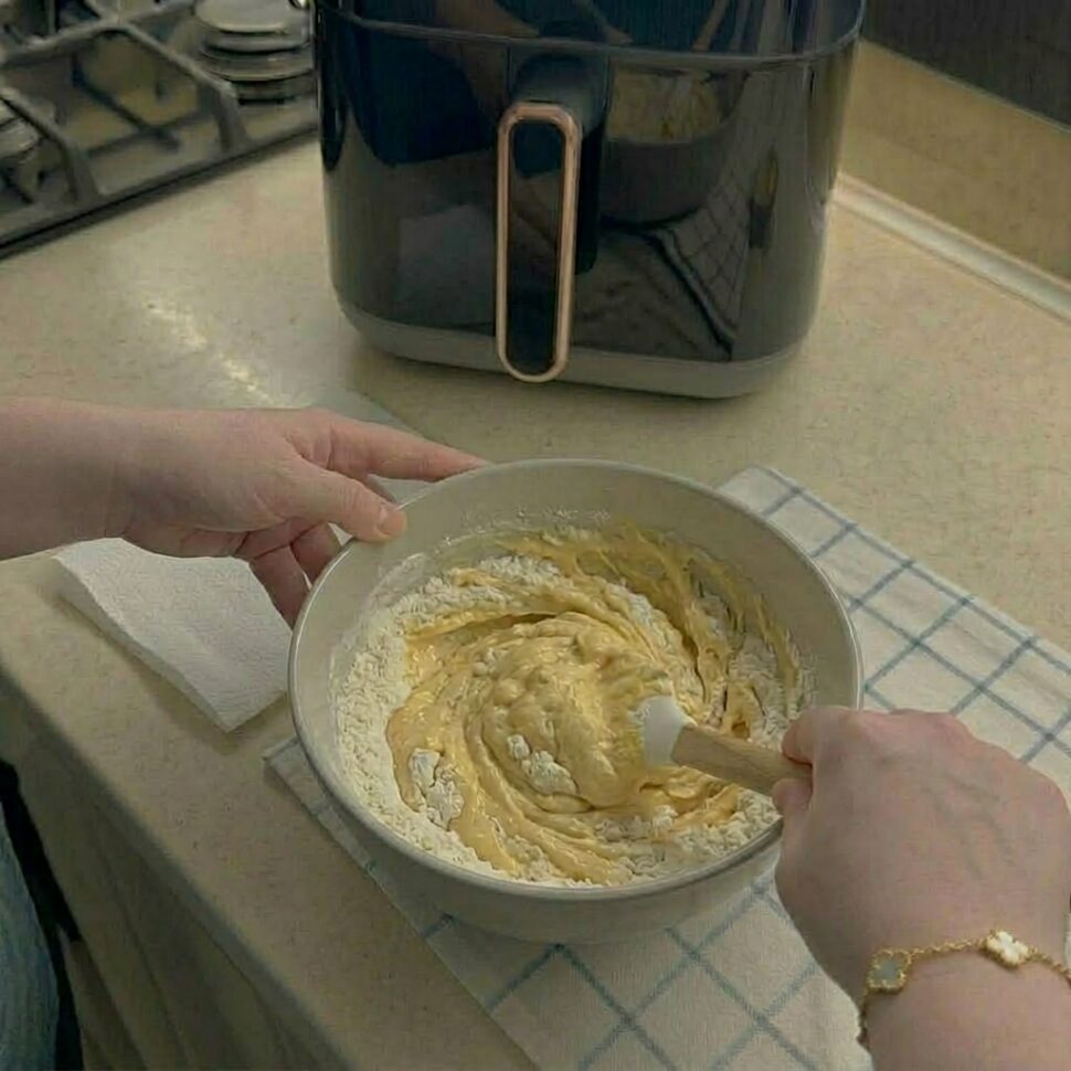 Wet and dry ingredients gently combined into a soft muffin batter in a bowl